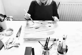 Janine Burrows painting in her studio.