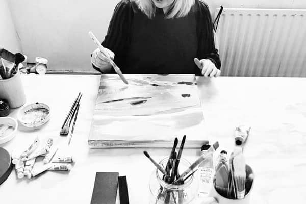 Janine Burrows painting in her studio.
