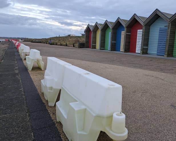 Plastic barriers are in place along the promenade after sand was washed away by winter storms. (Photo by National World)