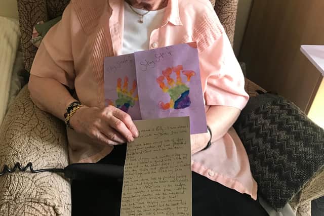 A resident at Summerhill Care Home with a child's letter.