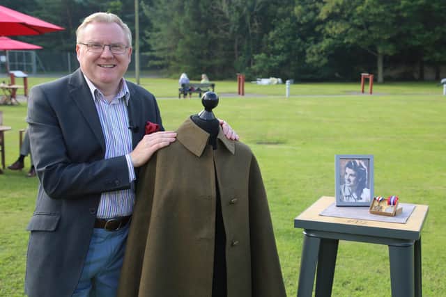 Mark Smith with a World War Two nurse’s cape and medals.