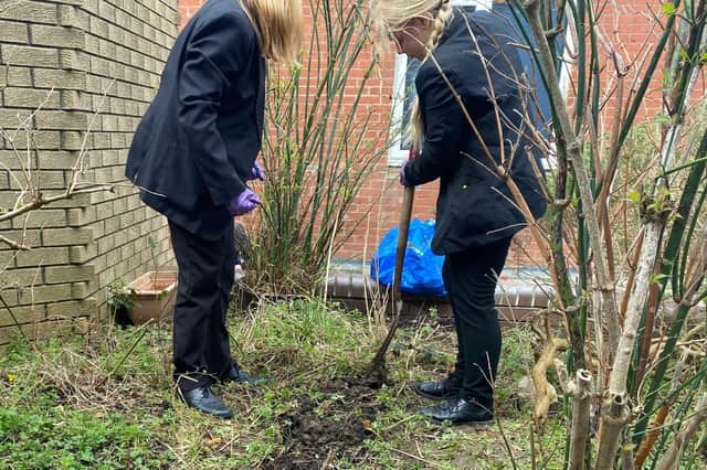 Members of the Environmental Club work on the school's green area.