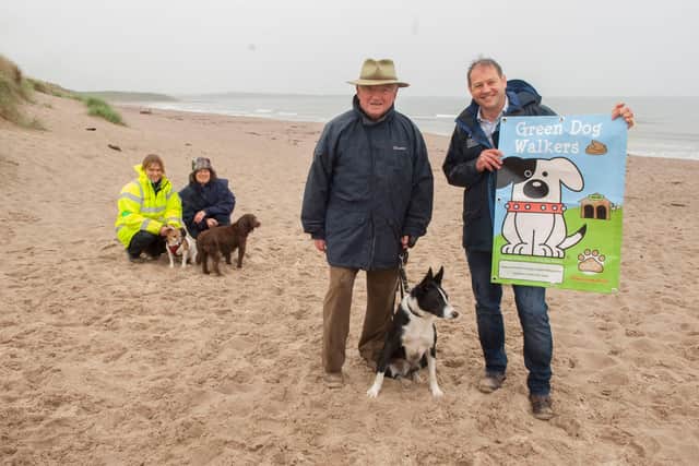 Northumberland County Council promotes its Green Dog Walkers scheme at Warkworth beach.