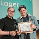 Matthew Brown, head brewer at Twice Brewed Brewing Company accepts the Gold Award for Juno Black
