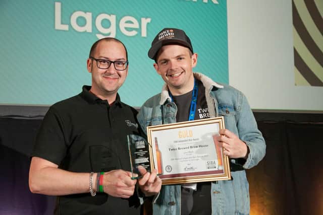 Matthew Brown, head brewer at Twice Brewed Brewing Company accepts the Gold Award for Juno Black