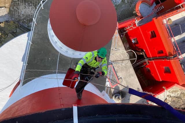 A painter scales the lighthouse walls. Picture: Trinity House