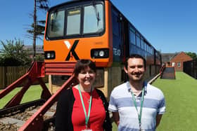 Deputy headteacher Sally Collins and outdoor learning teacher James Groundwater, who leads the train project, with the converted Pacer train.