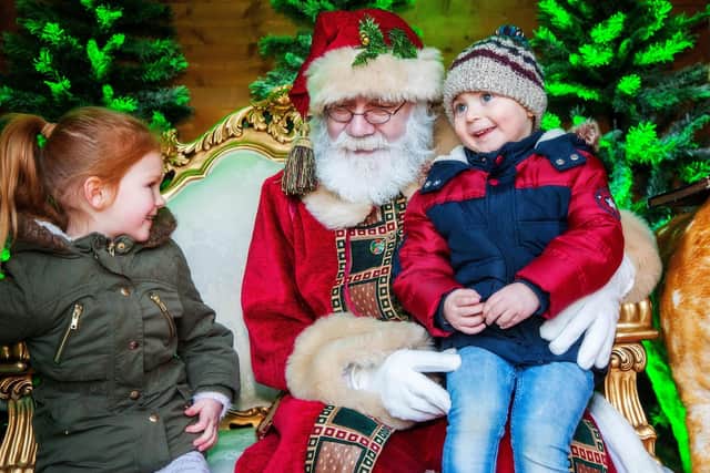 Picture shows two children telling Santa what they want for Christmas during a previous Father Christmas visit to Sanderson Arcade in Morpeth.