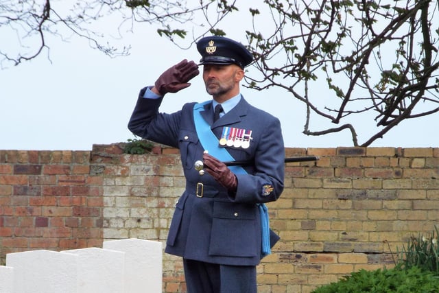 Warrant Officer Stephen Henderson, of RAF Boulmer, salutes the fallen.