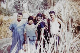 Bridget Gubbins, then Bridget Ashton, with a village family in the Sahara, 1965.