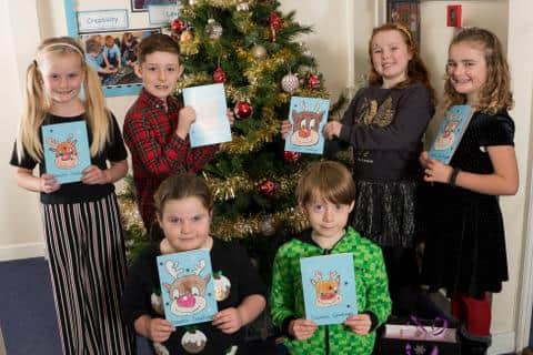 Children from Holy Trinity First School in Berwick with Christmas cards they designed for Northumbria Healthcare NHS Foundation Trust to go to patients at the local hospital. Picture by Richard Rayner.