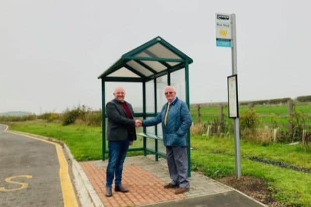 Coun David Towns and Coun Brian Moon, chairman of Hebron Parish Council, at one of the new bus shelters in Fairmoor.