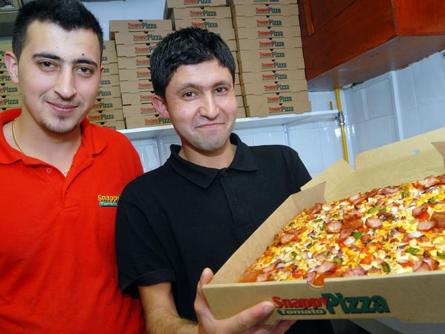 Staff at the Snappy Tomato Extra pizza shop in 2012
