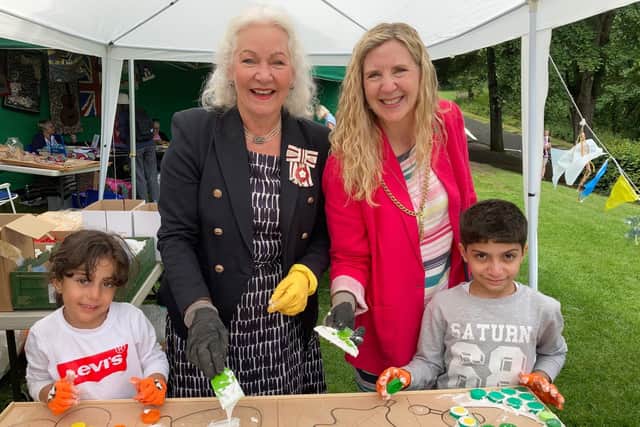 Caroline Pryer and Morpeth Mayor Alison Byard help young visitors to Picnic in the Park make a mosaic.