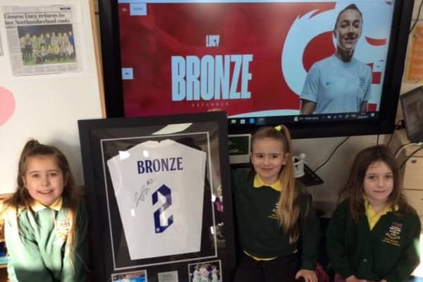 Holy Island pupils with the Lucy Bronze shirt.