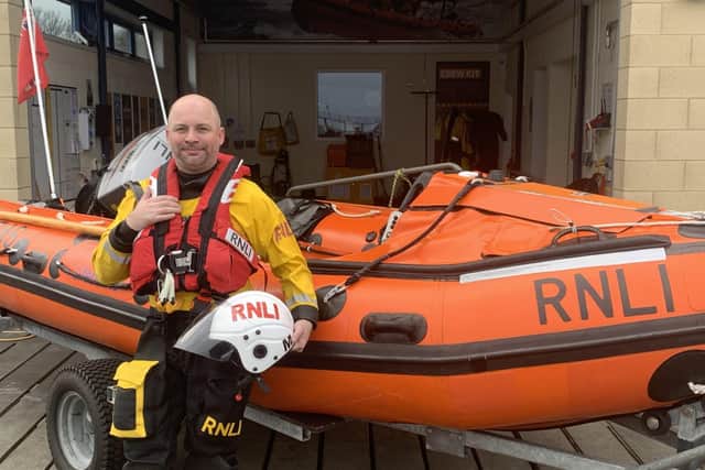 Paul Whittle with the station's D class lifeboat. (Photo by RNLI Blyth)