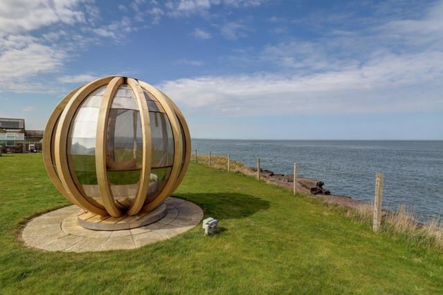 The rotating sphere garden pod which catches the last of the day's sun with views across the entire stretch of Druridge Bay.