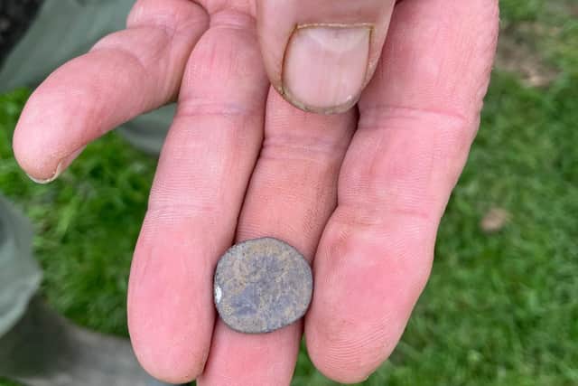 A Roman denarius coin found at the enclosure site.
