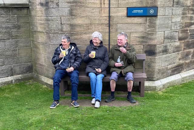 Taking shelter and keeping warm as Bamburgh Castle's grounds reopen to visitors.