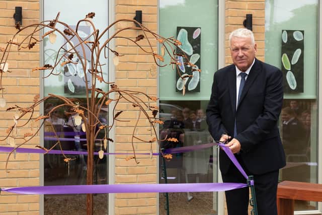 Ian Lavery MP cuts a ribbon to officially unveil a new memorial tree in Ashington.