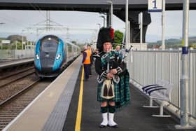 Sandy Mutch, the Border Piper, welcomes in the 6.16am TransPennine Express service to Reston Station.