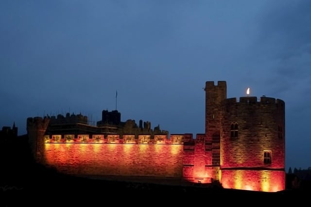 Alnwick Castle bathed in the colours of the Northumberland flag.