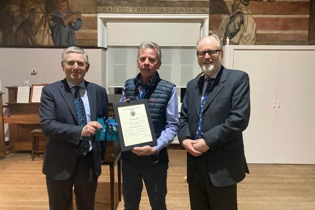 Tony Hall, centre, receives his Wooler Mart long service award from Scott Donaldson, managing director of Harrison & Hetherington and Lord James Joicey, president of the Glendale Agricultural Society.