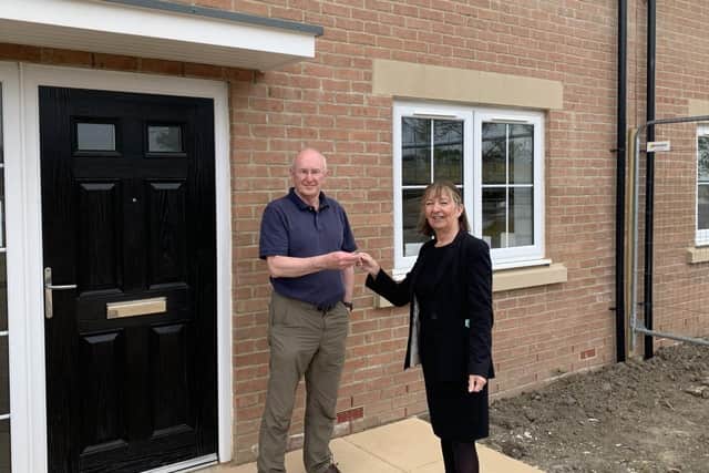 Alan Hudson, the latest buyer to move in at Southfields, receives his keys from Lynn Grant of WalkersXchange.