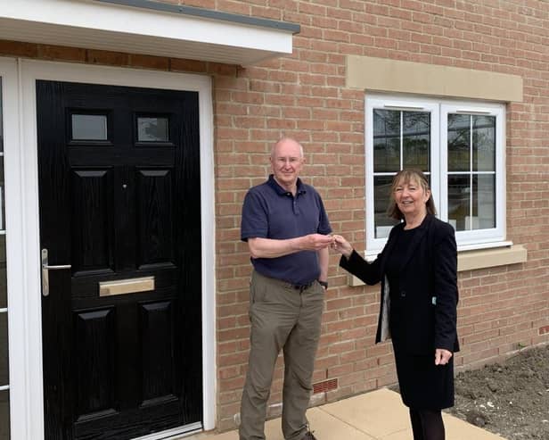Alan Hudson, the latest buyer to move in at Southfields, receives his keys from Lynn Grant of WalkersXchange.