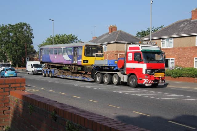 One half of the train arriving on a lorry at the school.