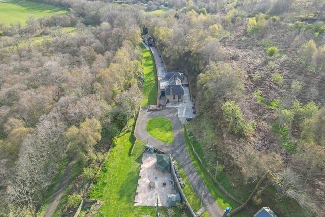 An aerial view of the property and surrounding woodland.