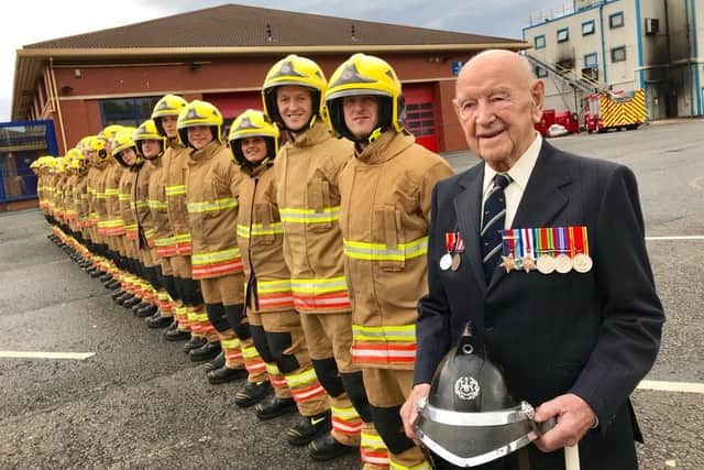 Joe Dixon on his 105th birthday with TWFRS new recruits on the training parade ground.