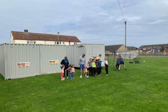 Containers on the grassed area used by children in James Street, Seahouses.