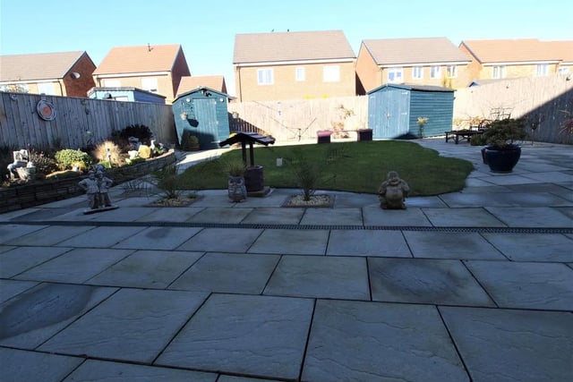 To the rear is a well maintained enclosed garden area, laid to decorative paving incorporating a patio/terrace area surrounding a sculptured area of lawn.