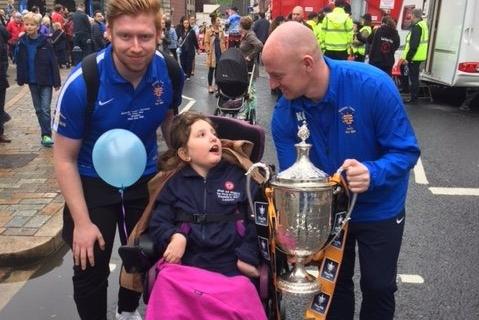 Leonie with two Morpeth Town players during Morpeth Fair Day.