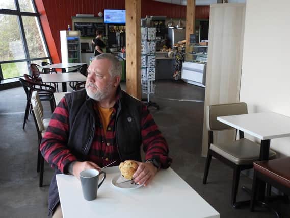 Morpeth resident Kelvin O'Hair tests out the Coronation Scone at the Hauxley Lookout Cafe.