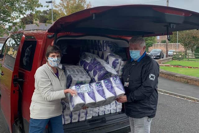 Rachel Sinton and Des Hood with a vehicle load of toilet rolls for Wooler Food Bank.