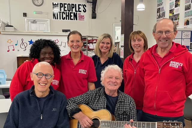 Ray and Billy with guitar with volunteers from The People’s Kitchen.
