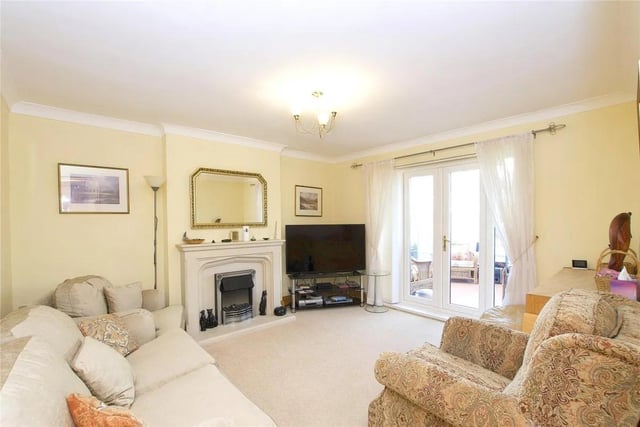 The main living room is flooded with natural light and has access to the conservatory.