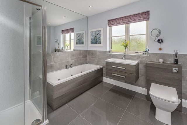 The en-suite is beautiful featuring the large grey high gloss tiling and matching units.