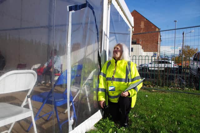 Railway Medical Practice receptionist Joan Angus surveys the damaged tent.