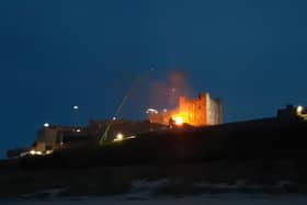 A fire at Bamburgh Castle as filming takes place for a new Indiana Jones movie.