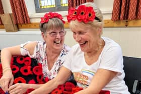 Volunteers help to create Alnwick's poppy cascade.
