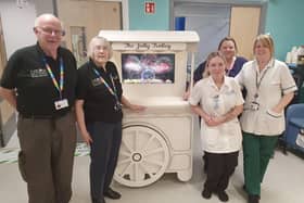Hospital volunteers and ward staff with the new jolly trolley. (Photo by Bright)