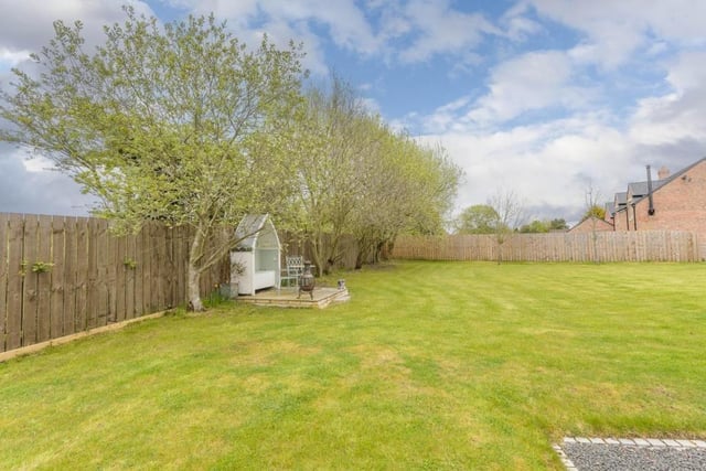 The property benefits from approximately half an acre of garden and associated land.