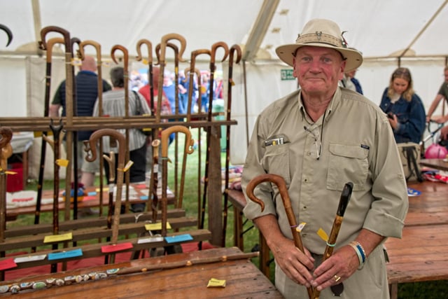 Prize winning stick dresser Paul Clark posing with two of his many prize winning sticks.
