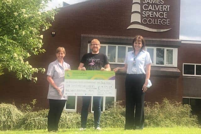 A cheque for over £1,300 is presented to HospiceCare North Northumberland.