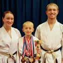 Jay pictured with all his medals won in his first year of competing with Sensei Gemma Gibson and Sensei Dylan Gibson.