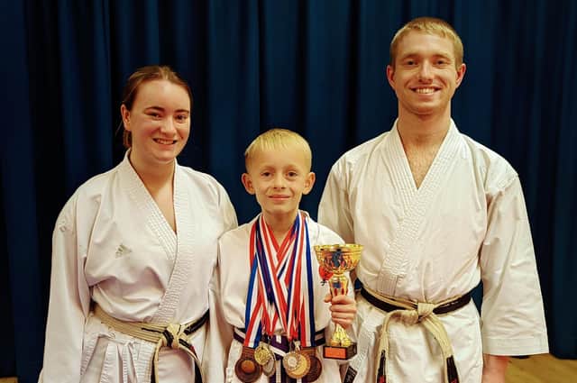 Jay pictured with all his medals won in his first year of competing with Sensei Gemma Gibson and Sensei Dylan Gibson.