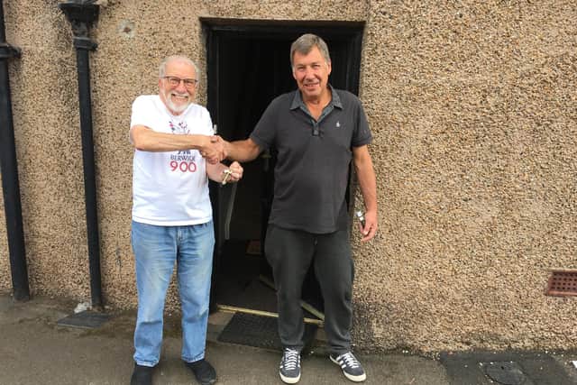 Keith Giddens, left, chairman of the buyout campaign committee, receives the keys to The Fishers Arms from previous owner Paul O'Keefe.